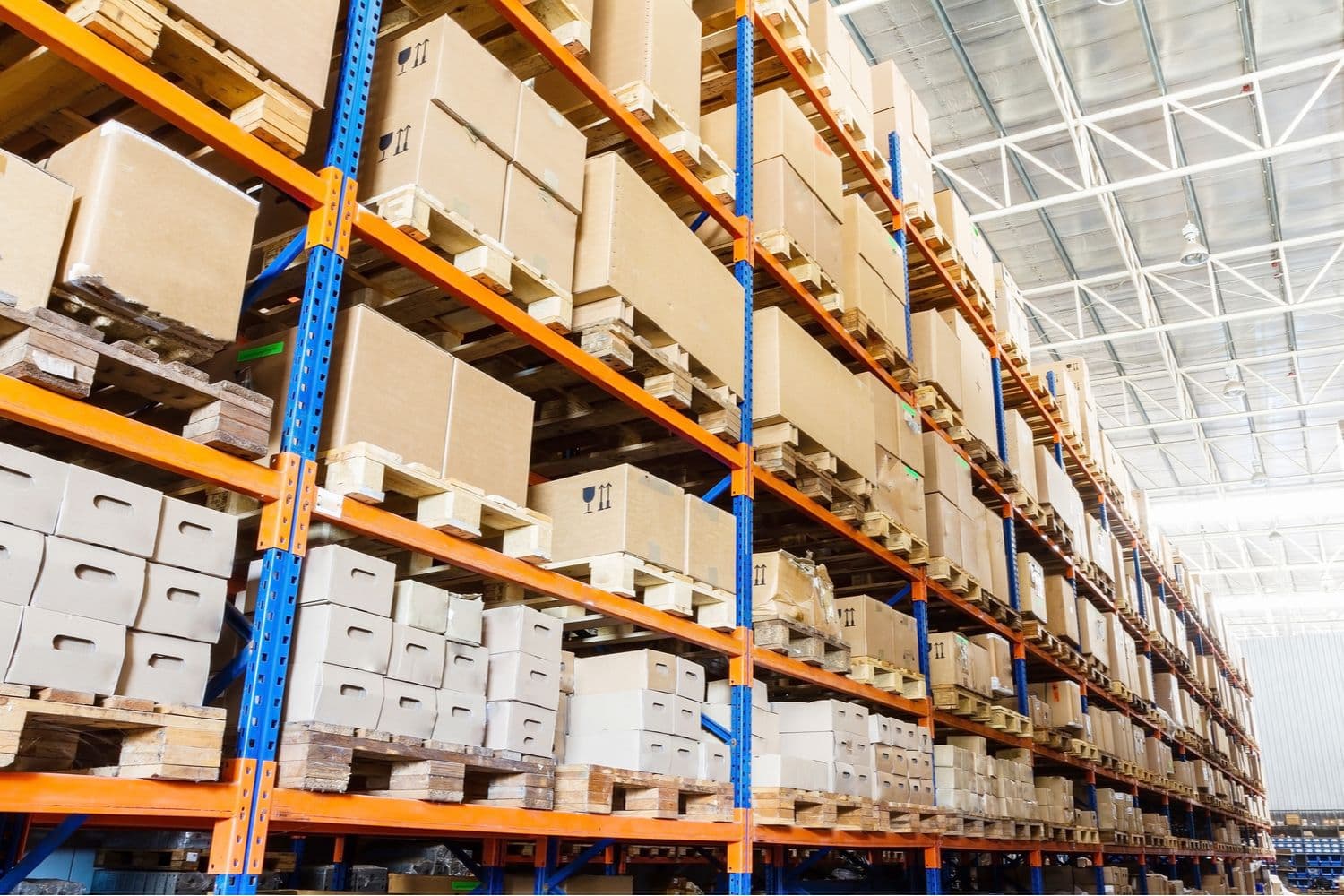 Storage cartons stacked on shelves in a warehouse.