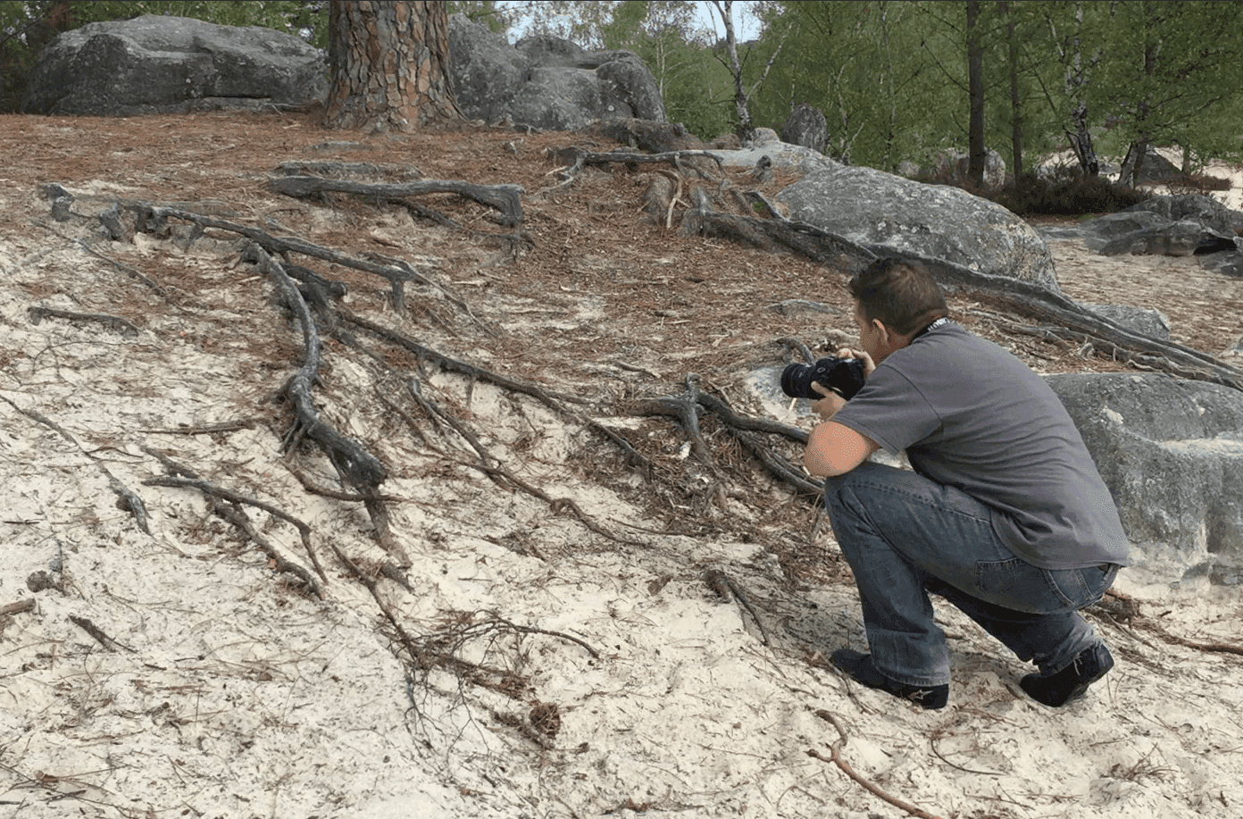 A picture of a man taking a picture in the woods