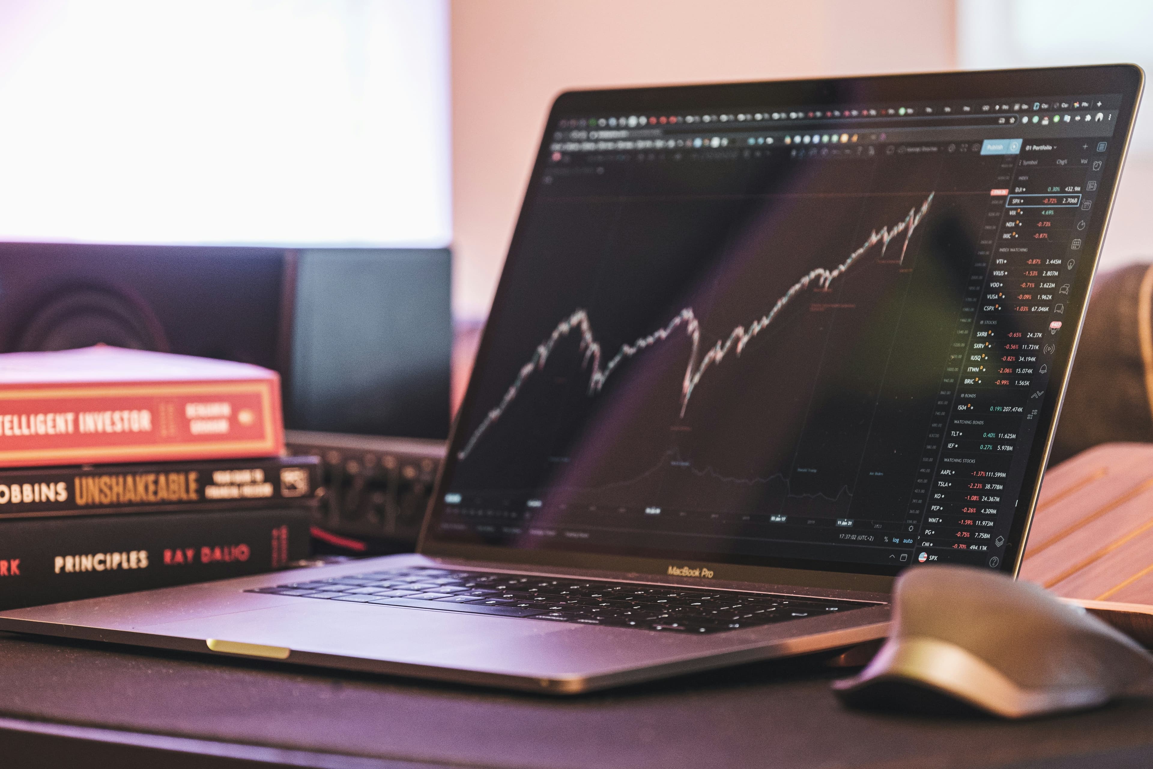 Laptop screen showing a rising graph line. (Yorgos Ntrahas/Unsplash)