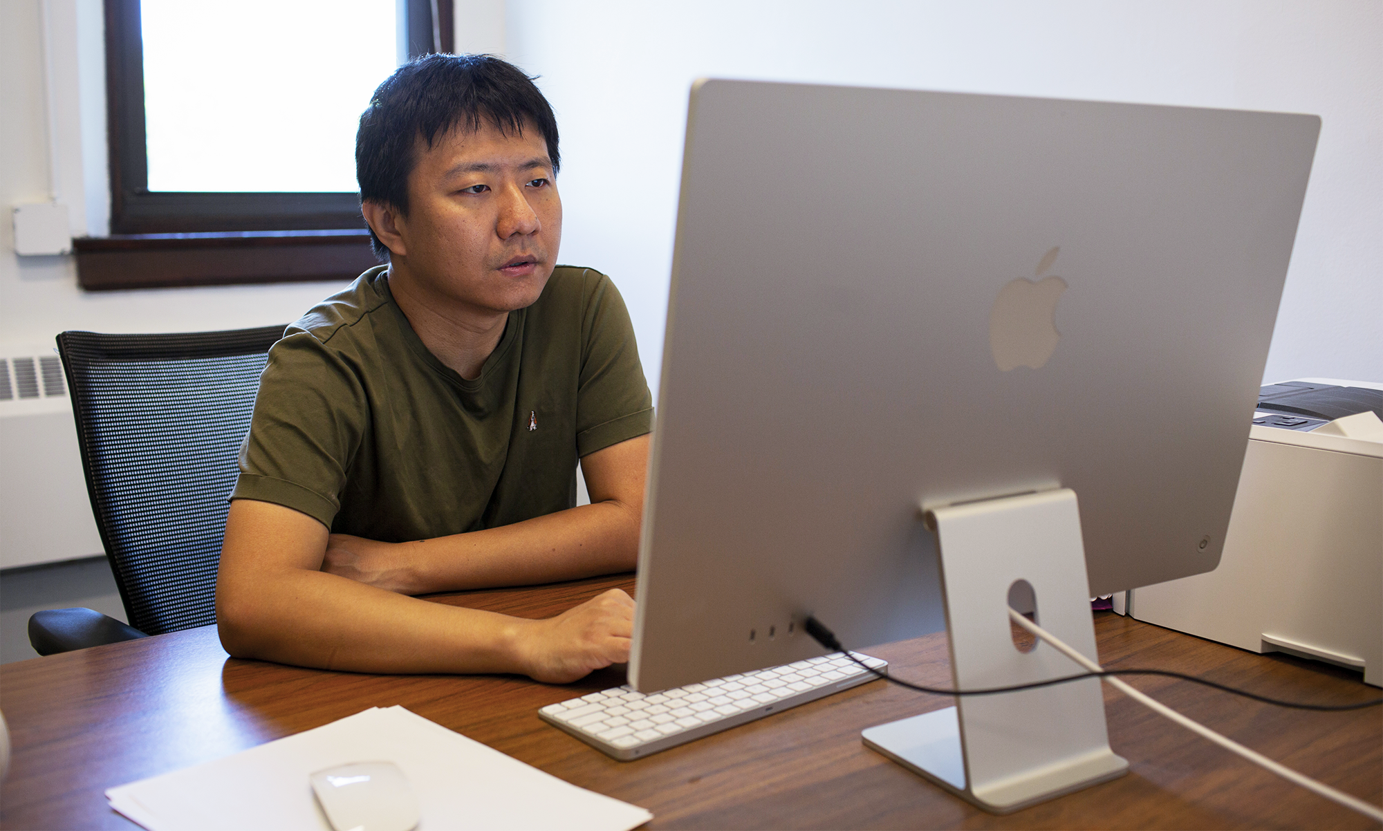 A man looking at his computer monitor.