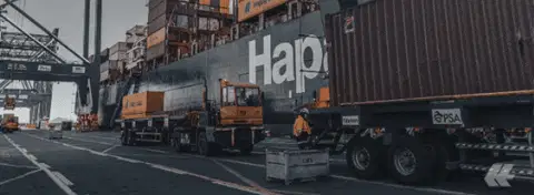 A container ship or shipping container being discharged