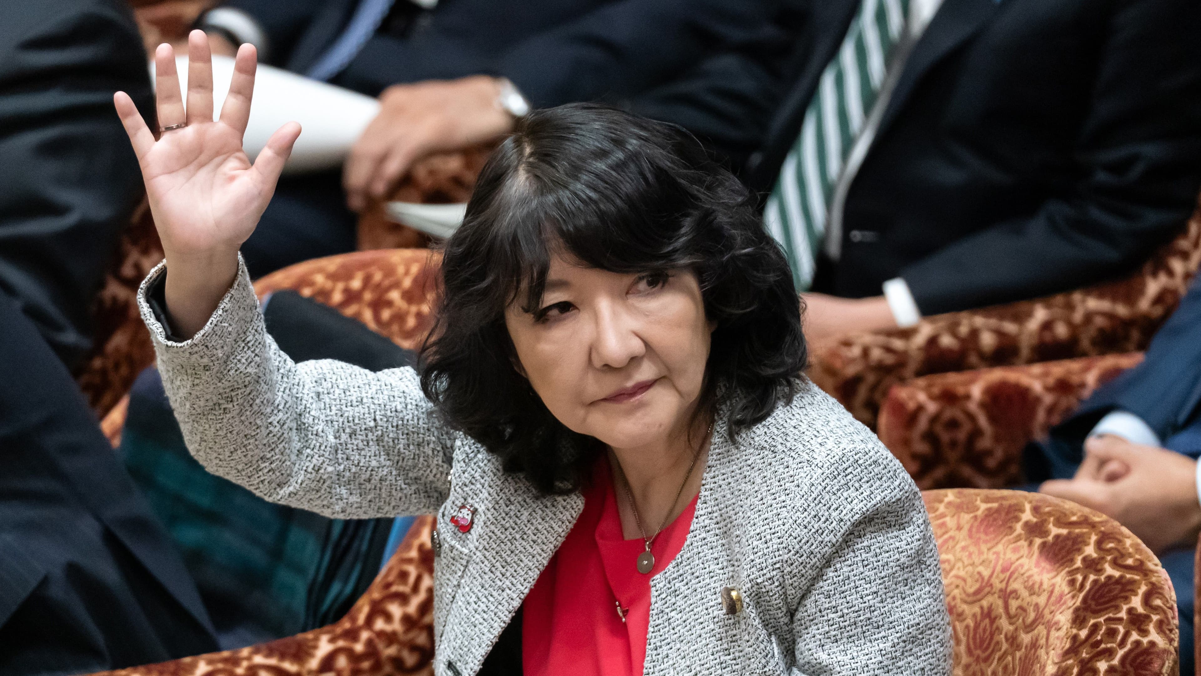 Japanese Finance Minister Satsuki Katayama raises her hand