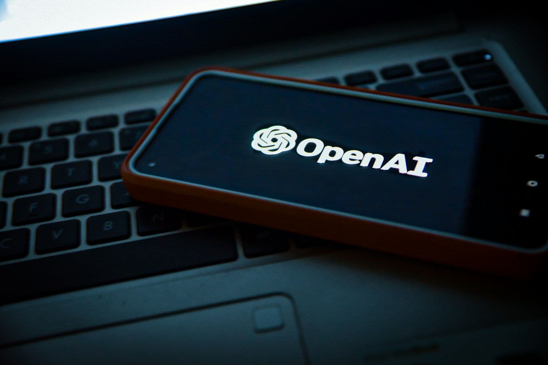 OpenAI logo on a mobile phone. (Unsplash)