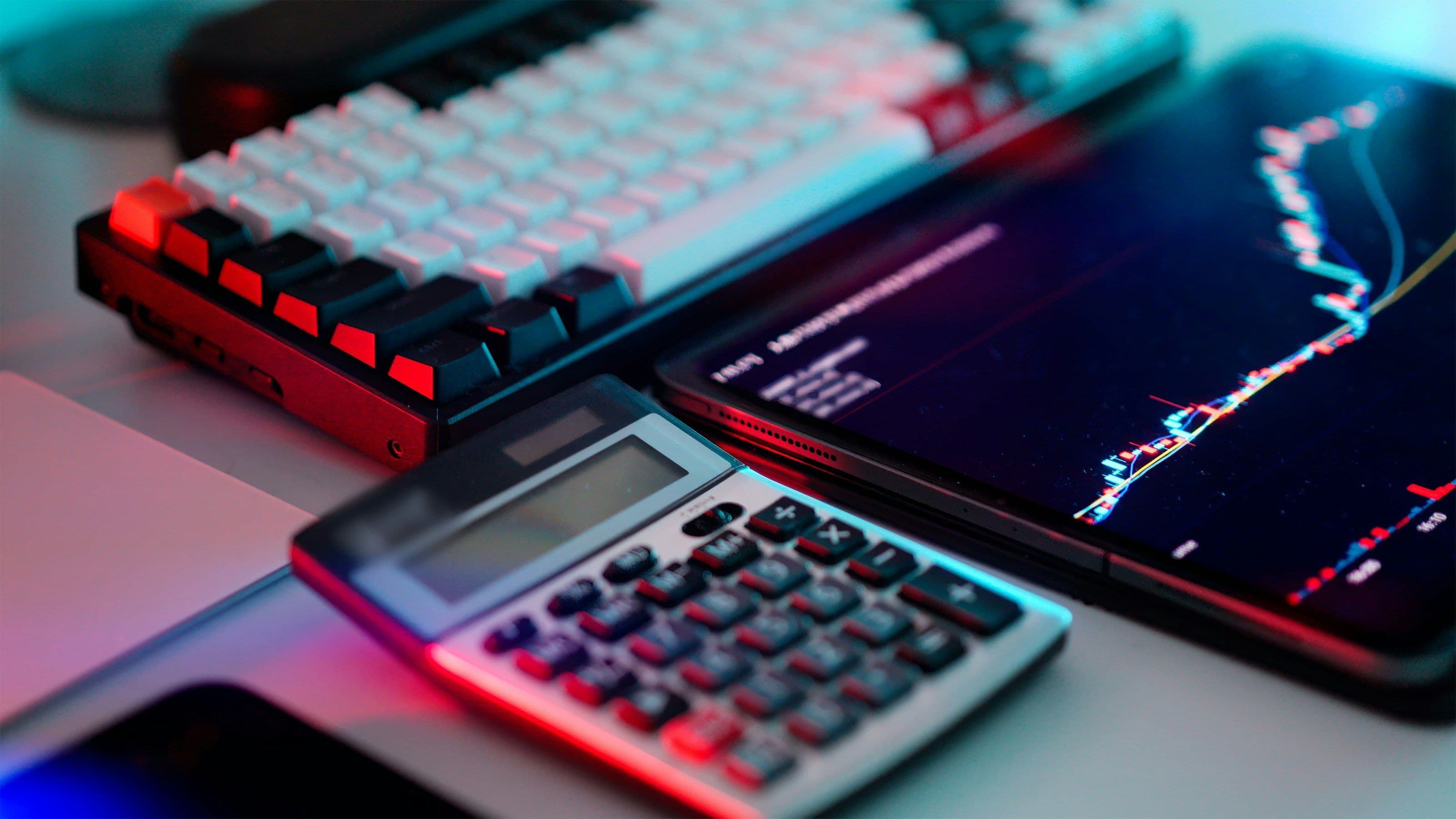 crypto currency exchange chart tablet screen calculator. (Jakub Żerdzicki/Unsplash)