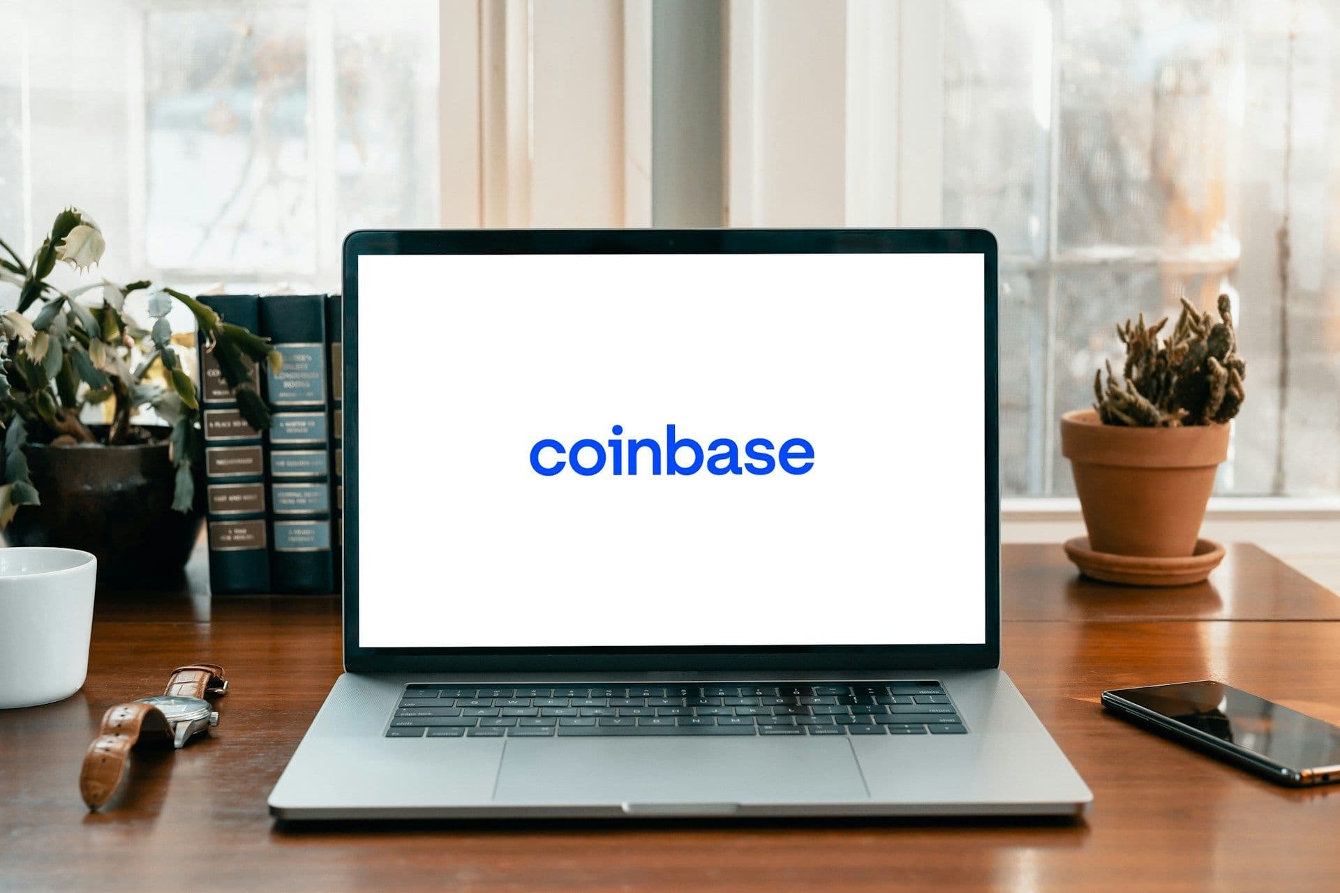 Coinbase logo shown on a laptop screen