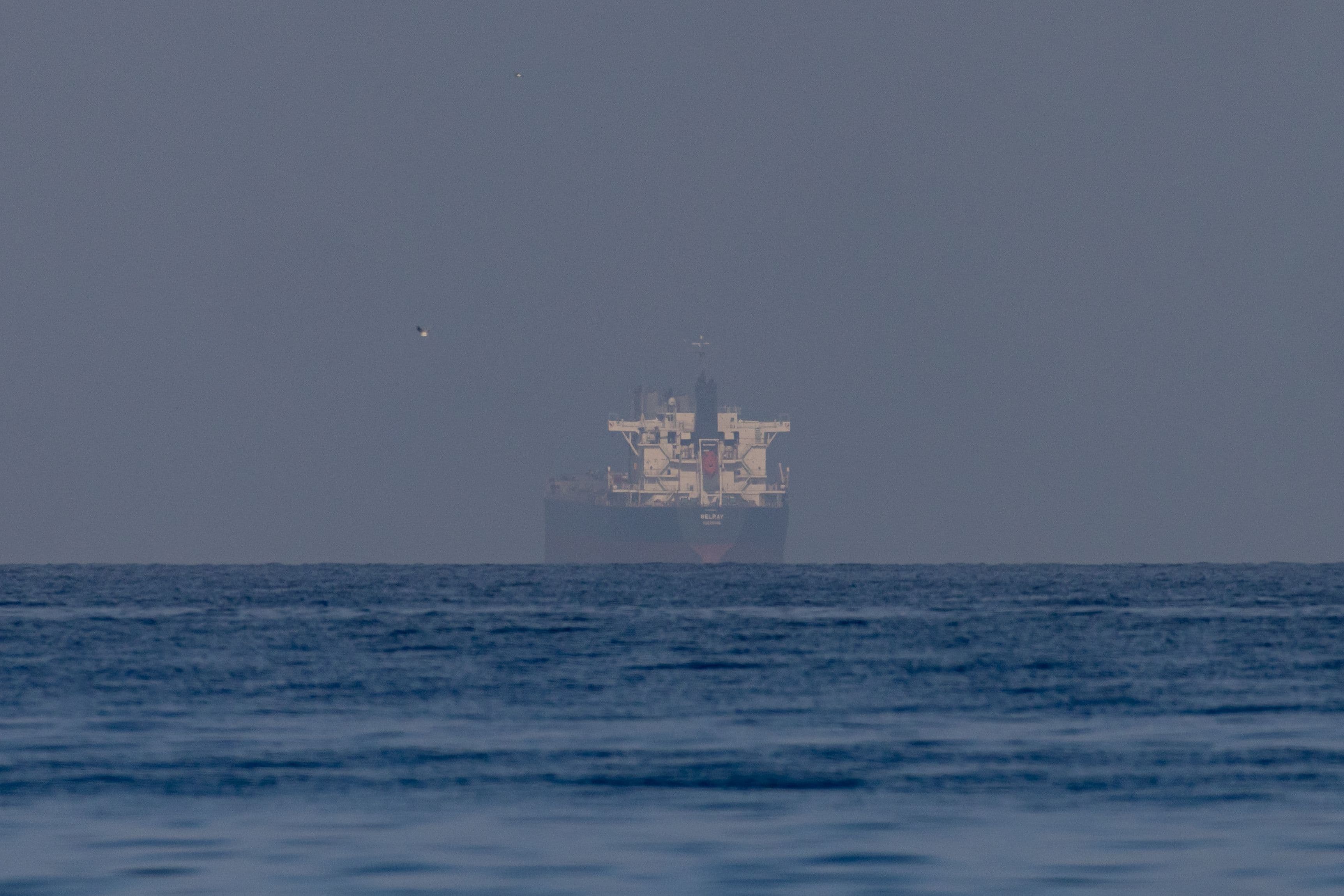 A bulk carrier shrouded in mist awaits entry to the Strait of Hormuz (Getty)