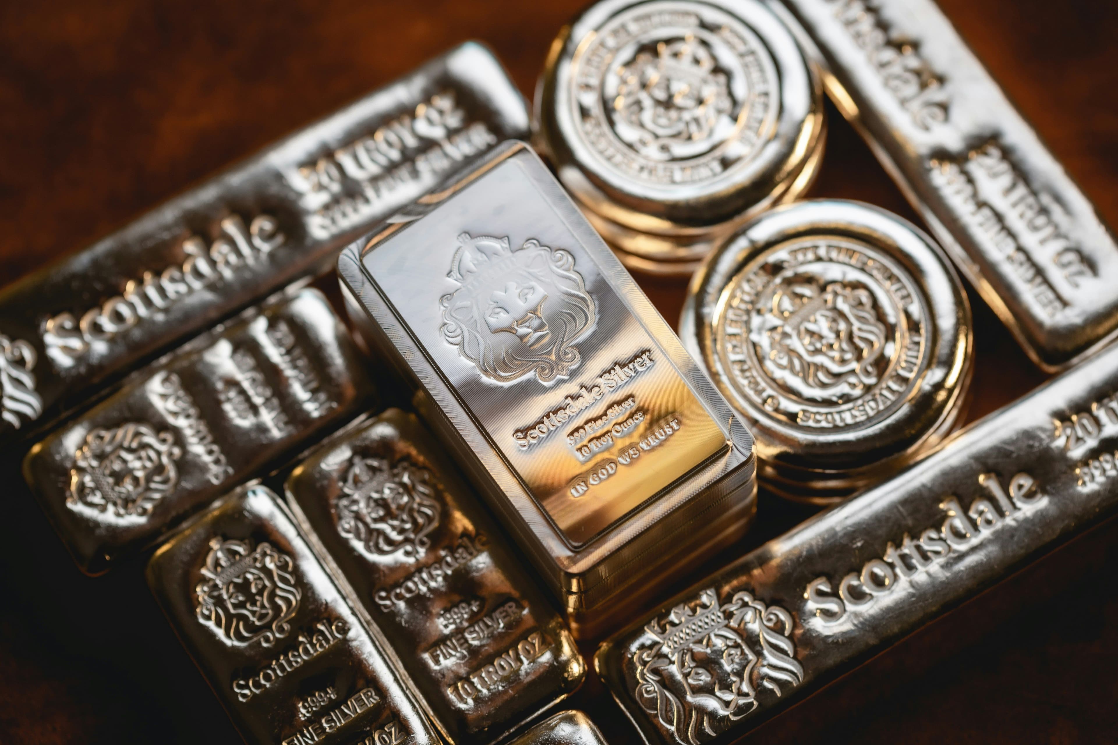 Piles of gold and silver bars. (Scottsdale Mint/Unsplash)