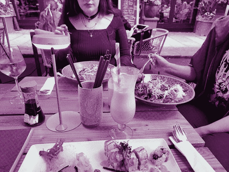 The picture shows my friends at a restaurant and is made up only of shades of pink, as well as black and white.
