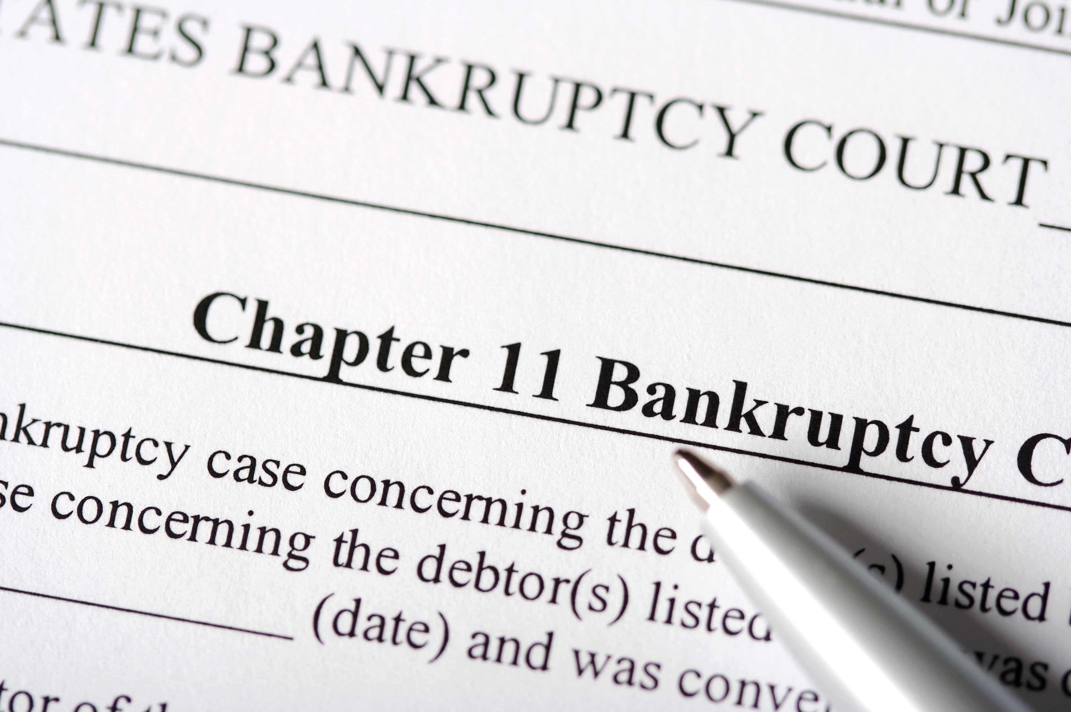 A pen points to the words "Chapter 11 Bankruptcy" at the top of a form. (FuzzMartin/Getty Images)