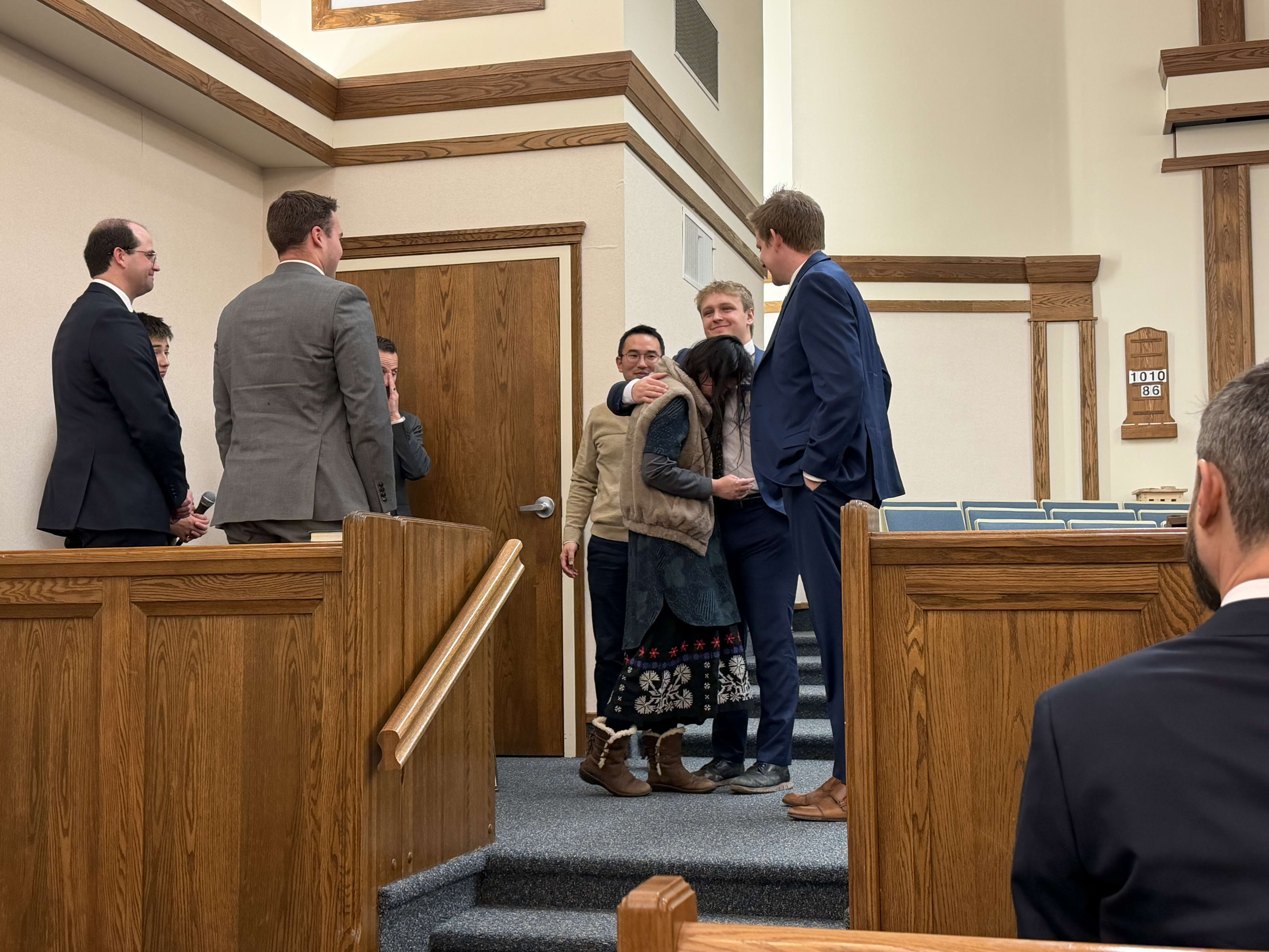 Bei and Elder Phillips hugging after the confirmation