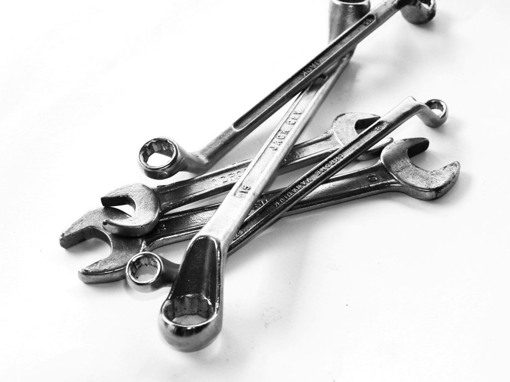 grayscale photo of combination wrenches